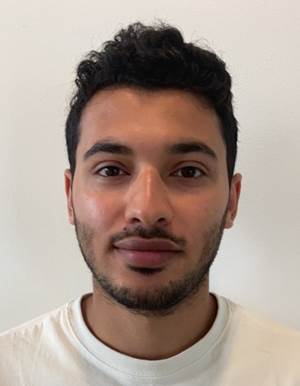 A person with a beard and mustache

Description automatically generated