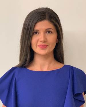 A person in a blue dress

Description automatically generated